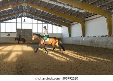 Woman Rides At A Trot In The Riding Hall