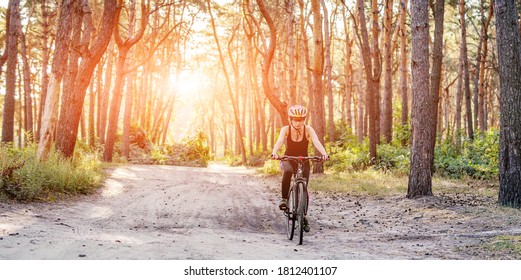 Woman Riding Bicycle In Forest