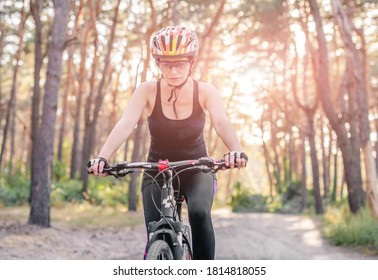 Woman Riding Bicycle In Forest