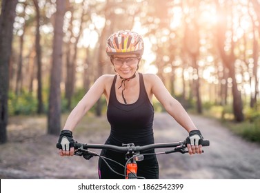 Woman Riding Bicycle In Forest