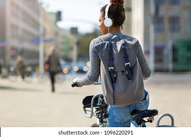 Woman Riding Bicycle On City Street