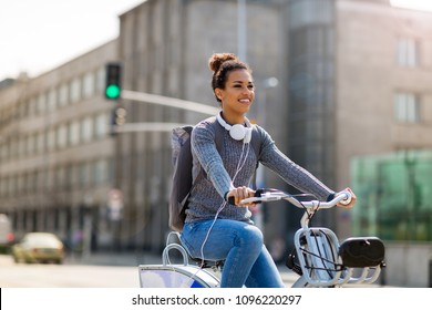 Woman Riding Bicycle On City Street