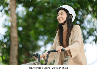 A woman is riding a bicycle in a park - Powered by Shutterstock