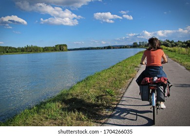 Woman Riding Bicycles Along The Danube River On The Famous Cycling Route Donauradweg. Lower Austria, Europe - August, 2016