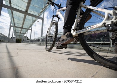 Woman Riding Bike At City On Sunny Day