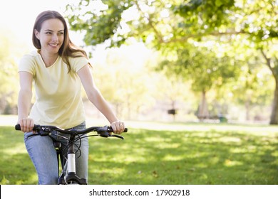 Woman Riding Bike In Park