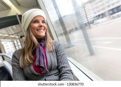 Woman Riding In A Bus And Looking Happy