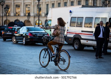 Woman Riding A Bycicle On The Streets Of Paris September 2016