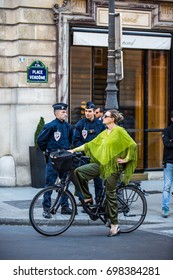 Woman Riding A Bycicle On The Streets Of Paris September 2016