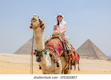 Woman Riding A Camel In The Desert