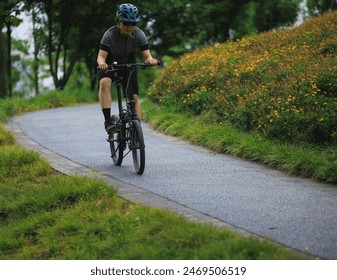 Woman riding folding bike in sunny park - Powered by Shutterstock