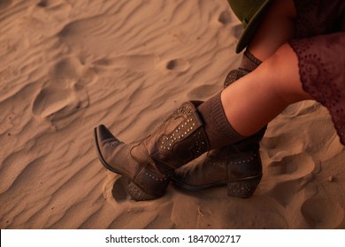 Woman Riding High Cowboy Boots Made Of Leather On Sand During Sunset