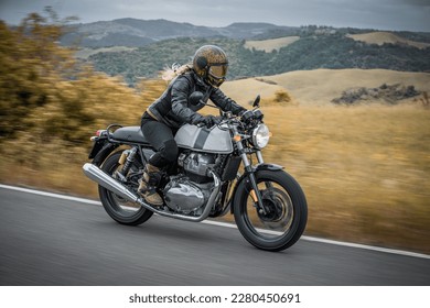 woman riding on classic motorcycle 