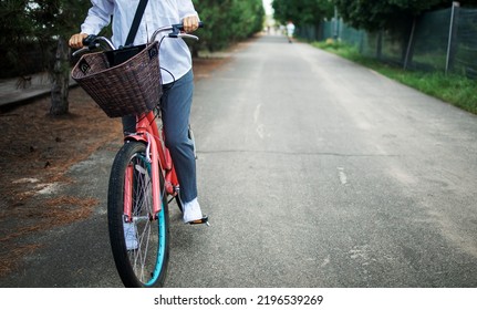 Woman Riding A Pink Bike In Park Trail On Spring