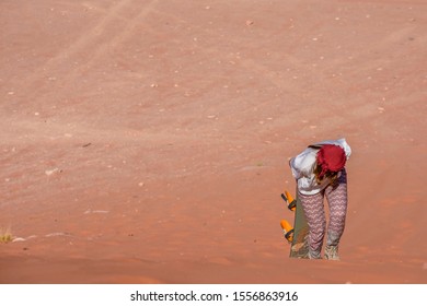 A Woman Riding A Sandboarding