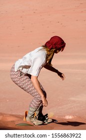 A Woman Riding A Sandboarding