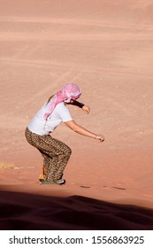 A Woman Riding A Sandboarding