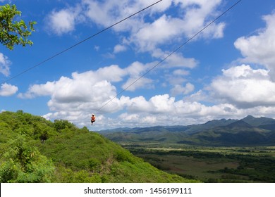 Woman riding in zip line in the Valley of the Sugar Mills in Trinidad Cuba - Powered by Shutterstock