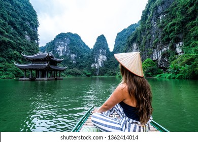 A woman in a river boat in Ninh Binh.  Mountains of northern Vietnam.