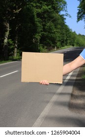 Woman at the roadside with a blank sign