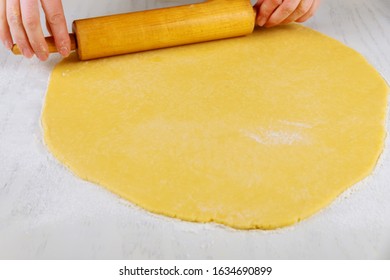 Woman Rolling Dough With Pin For Making Sugar Cookies On White Table.