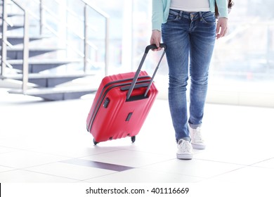 Woman Rolling A Large Red Suitcase, Close Up