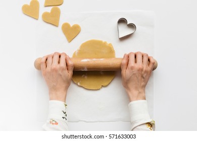 Woman Rolling Out Sweet Dough To Make Heart Shaped Biscuits