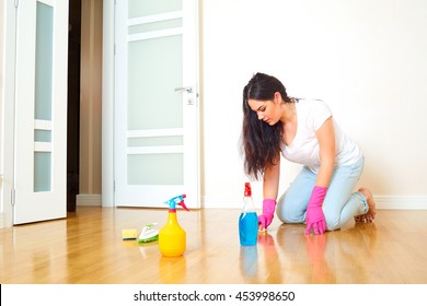 A Woman In A Room Of The House Cleaning The Floor In Rubber Gloves. Mom Makes Wet Cleaning Of The Apartment. Concept Of Cleanliness And Order In The House.