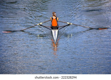 The Woman Rower In A Boat, Rowing On The Tranquil Lake 