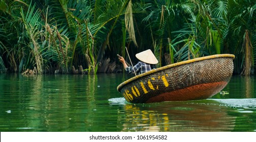 Woman rowing Vietnamese boat