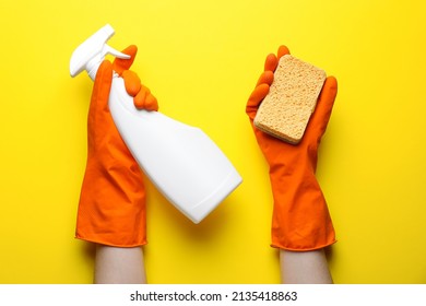 Woman In Rubber Gloves Holding Sponge And Detergent On Yellow Background, Top View