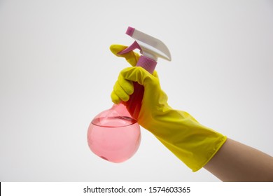Woman in rubber gloves holding water sprayer