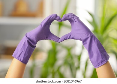 Woman In Rubber Gloves Making Heart With Her Hands At Home