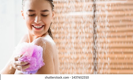 Woman Rubbing Body With Foam, Enjoying Refreshing Shower, Copy Space