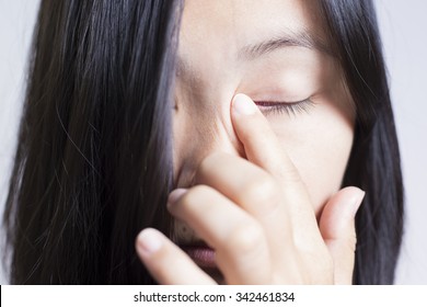 Woman Rubbing Her Eye