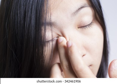 Woman Rubbing Her Eye