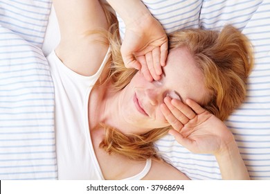 Woman Rubbing Her Eyes After Waking Up