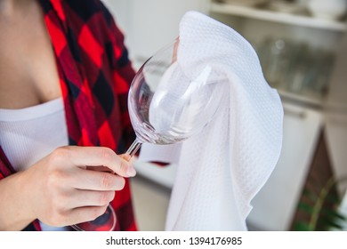 Woman Is Rubbing The Wine Glass With White Cloth In The Kitchen.