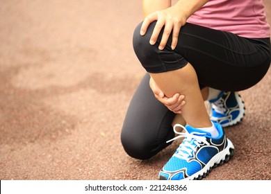 Woman Runner Hold Her Injured Knee