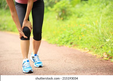 Woman Runner Hold Her Sports Injured Knee 