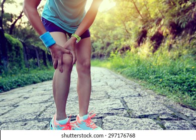 Woman Runner Hold Her Sports Injured Knee 