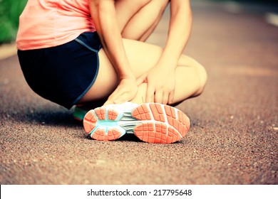 Woman Runner Hold Her Twisted Ankle 