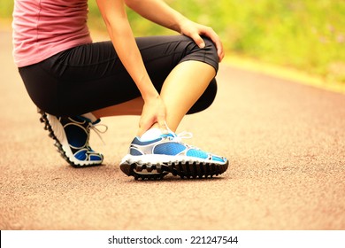 Woman Runner Hold Her Twisted Ankle 