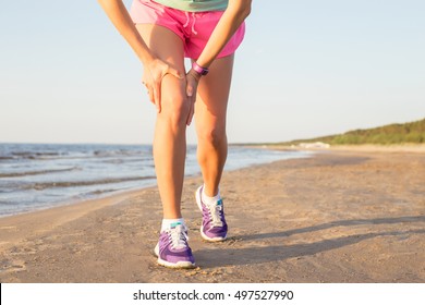 Woman Runner Holding Her Knee In Pain 