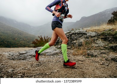 Woman Runner Run Mountain Race With Trail Vest For Running