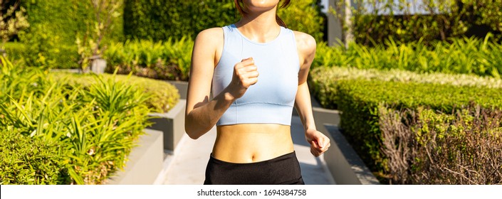 Woman Runner Running In City Park