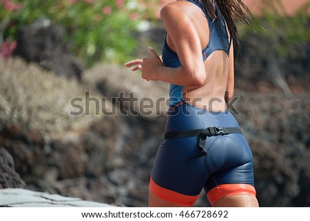 Woman runner running on triathlon race on sunny days