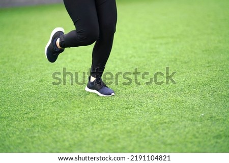 woman runner running with sport shoe in backyard lawn grass