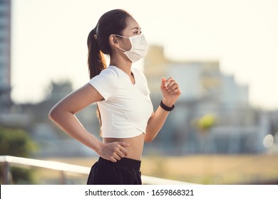 Woman Runners Morning Exercise She Wears A Nose Mask. Protection Against Dust And Viruses