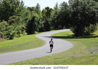 Woman Running Alone on S-Shaped Path
